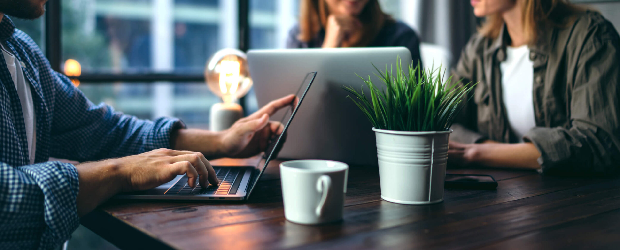 people working in a conference room on laptops