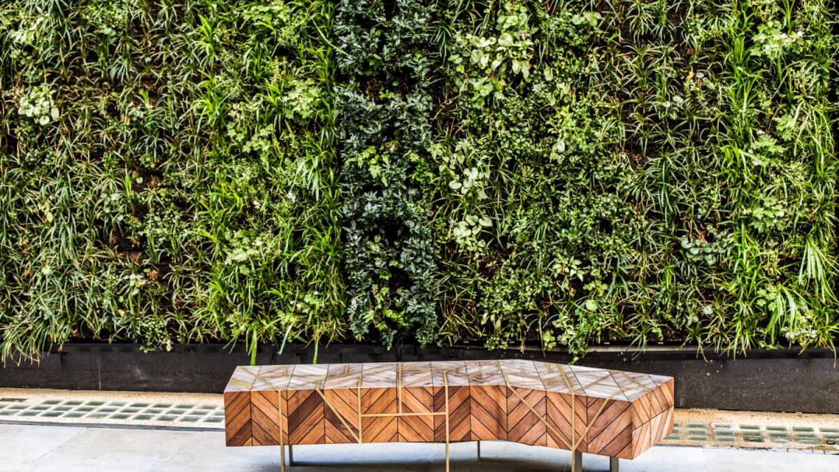 living wall and bench in the lobby of an office building