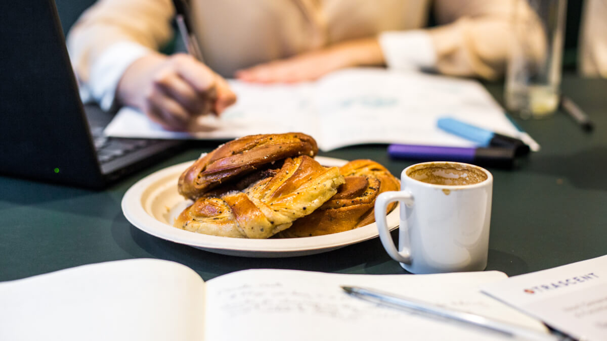 breakfast pastries and coffee on a work table