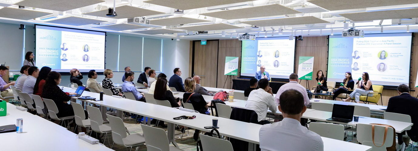 man reading agenda in conference auditorium